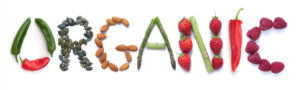 The word organic spelled out with fruits, veggies, and nuts