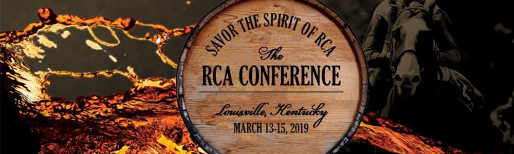 barrel with RCA Conference logo on the bottom with brown liquid and a man riding a horse in the background