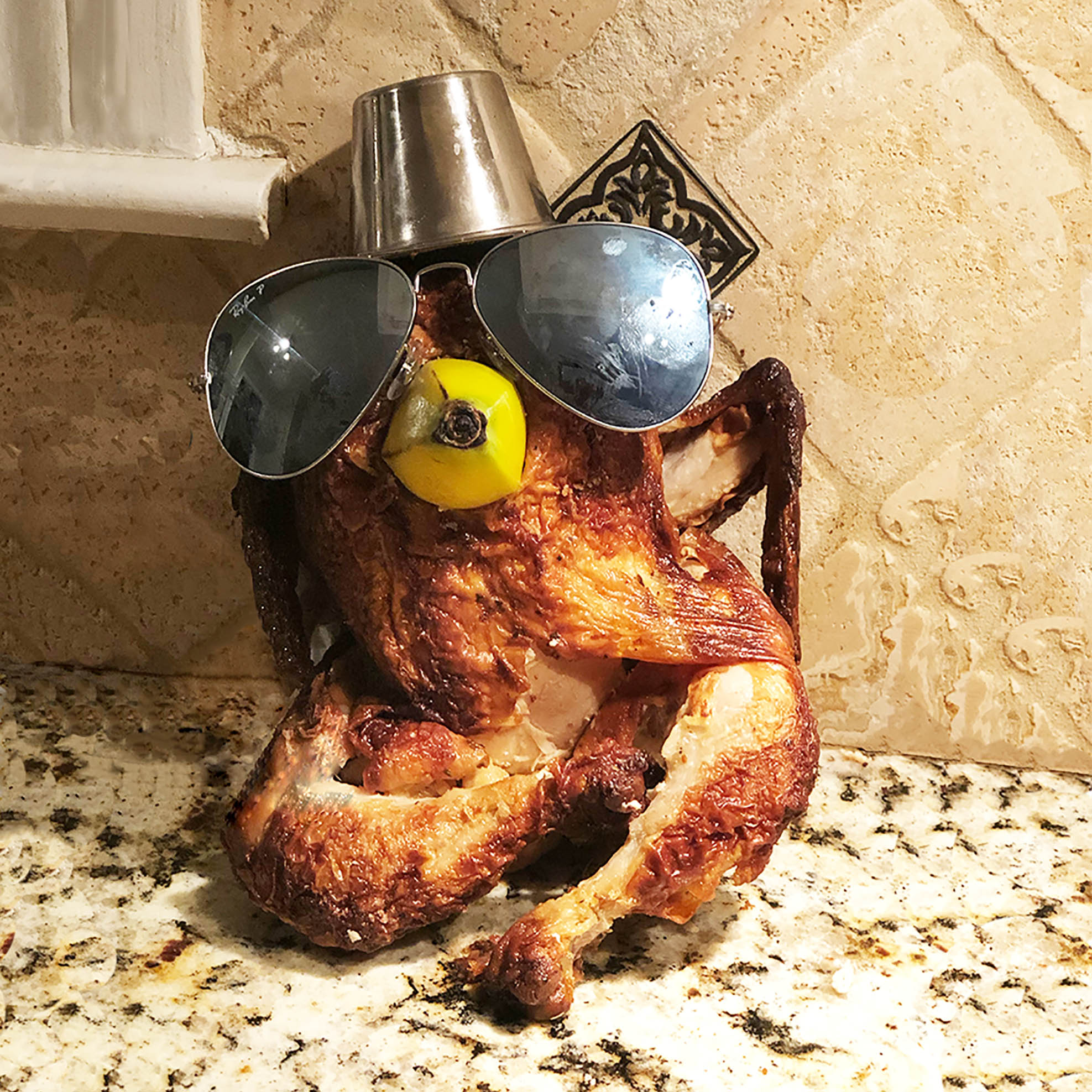 Cooked turkey with sunglasses and makeshift hate with a banana as a mouth